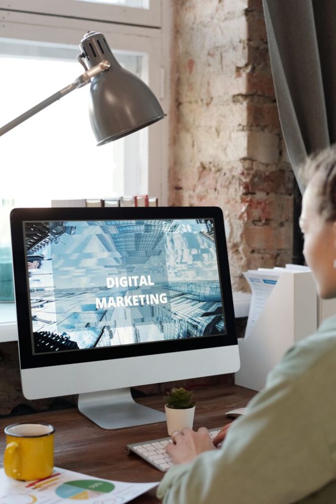 Modern home office setup with a focus on digital marketing on a computer screen.